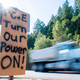 A sign calling for PG&E to turn the power back on is seen on the side of the road during a statewide blackout in Calistoga, California, on October, 10, 2019.
